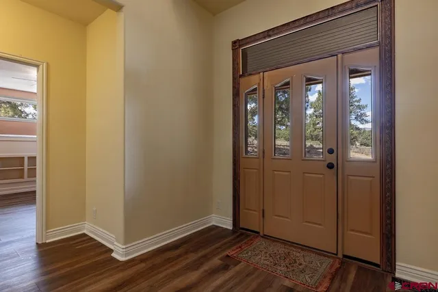 a view of front door with wooden floor