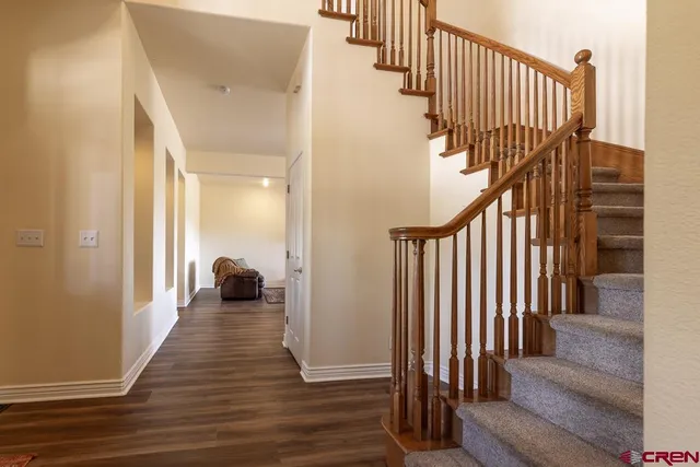 a view of a hallway with wooden floor and windows
