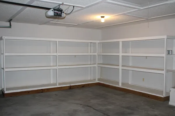 a view of an empty room with empty shelves