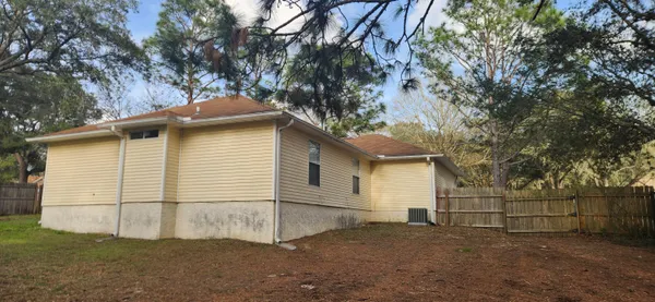 a backyard of a house with a large tree