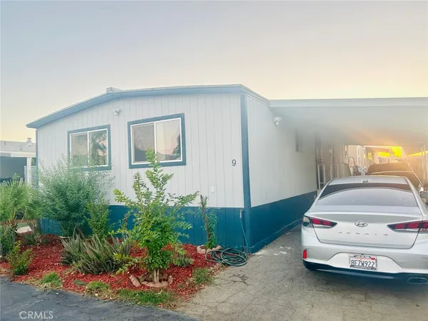 a car parked in front of yellow house