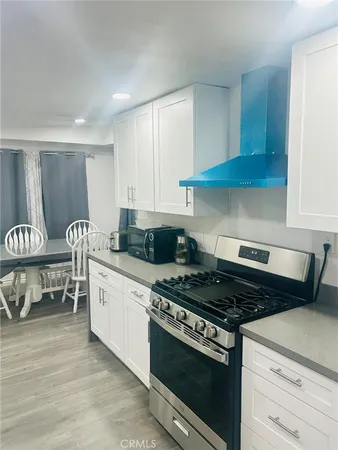 a kitchen with stainless steel appliances granite countertop a stove and a cabinets