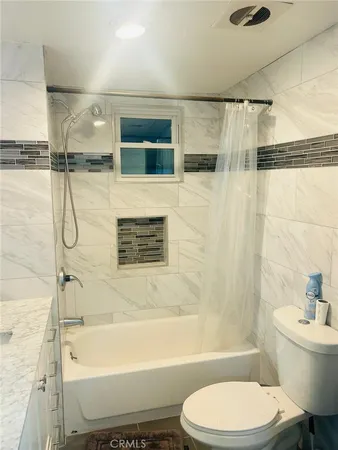 a bathroom with a toilet bathtub and shower
