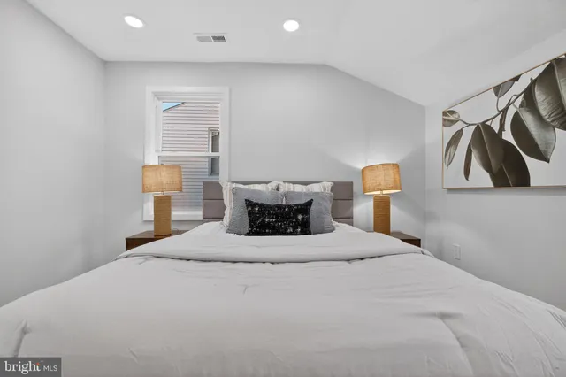 a bedroom with a bed and lamp