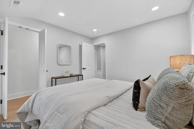 a bedroom with a large bed and a chandelier