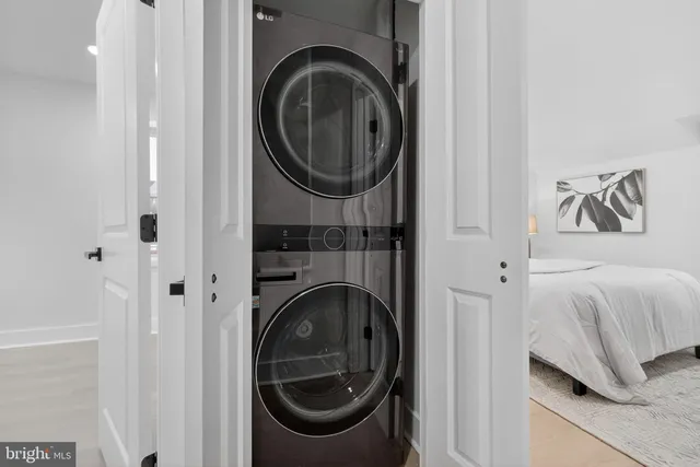 a view of a bedroom with washer and dryer
