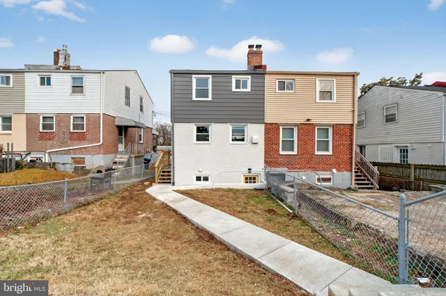 a front view of a house with large windows