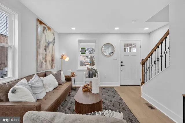 a living room with furniture and wooden floor
