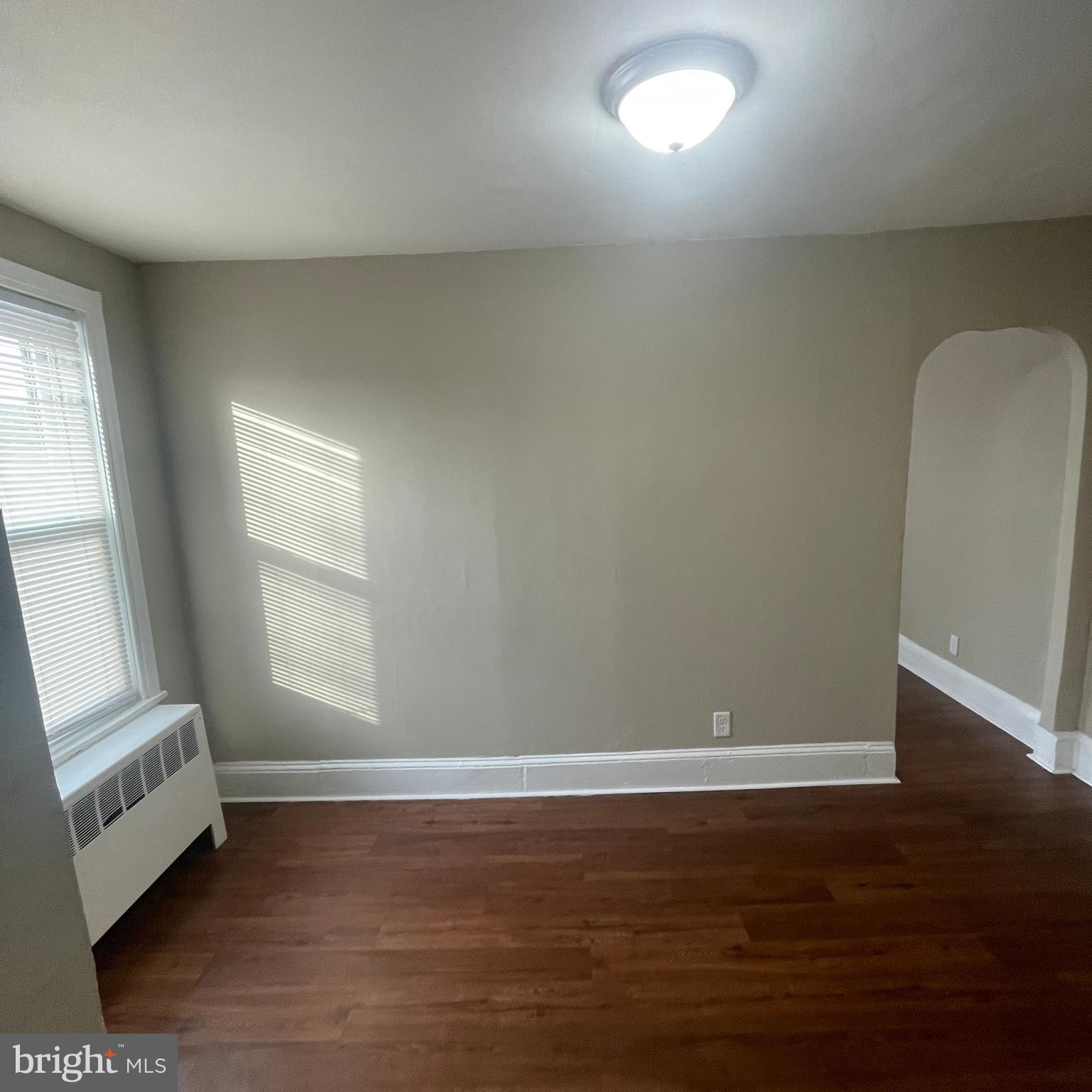 4971 Kershaw Street, Unit 4 Philadelphia, PA 19131 - Photo 4 of 7 an empty room with wooden floor and windows