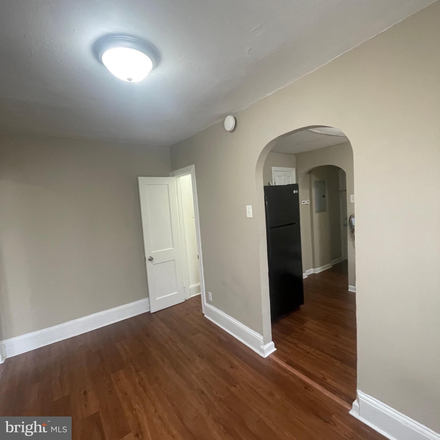 4971 Kershaw Street, Unit 4 Philadelphia, PA 19131 - Photo 5 of 7 an empty room with wooden floor and a window