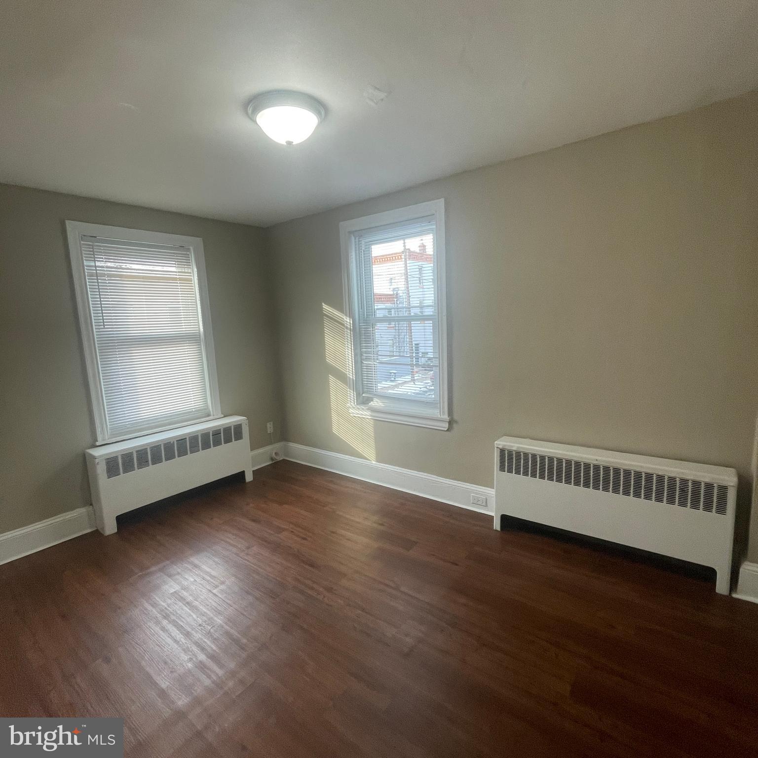 4971 Kershaw Street, Unit 4 Philadelphia, PA 19131 - Photo 6 of 7 an empty room with wooden floor and windows