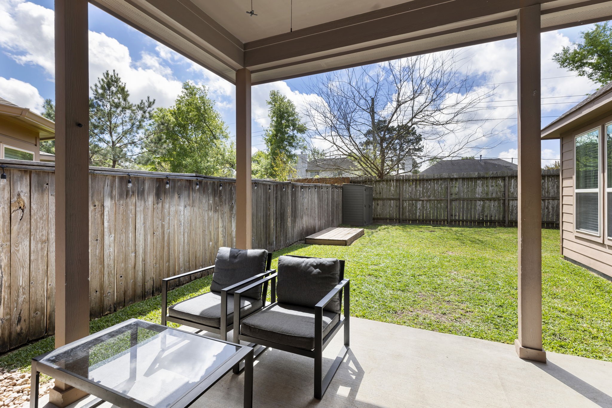 71 Sagamore Ridge Place The Woodlands, TX 77389 - Photo 31 of 34 a outdoor view with a sitting space and large trees