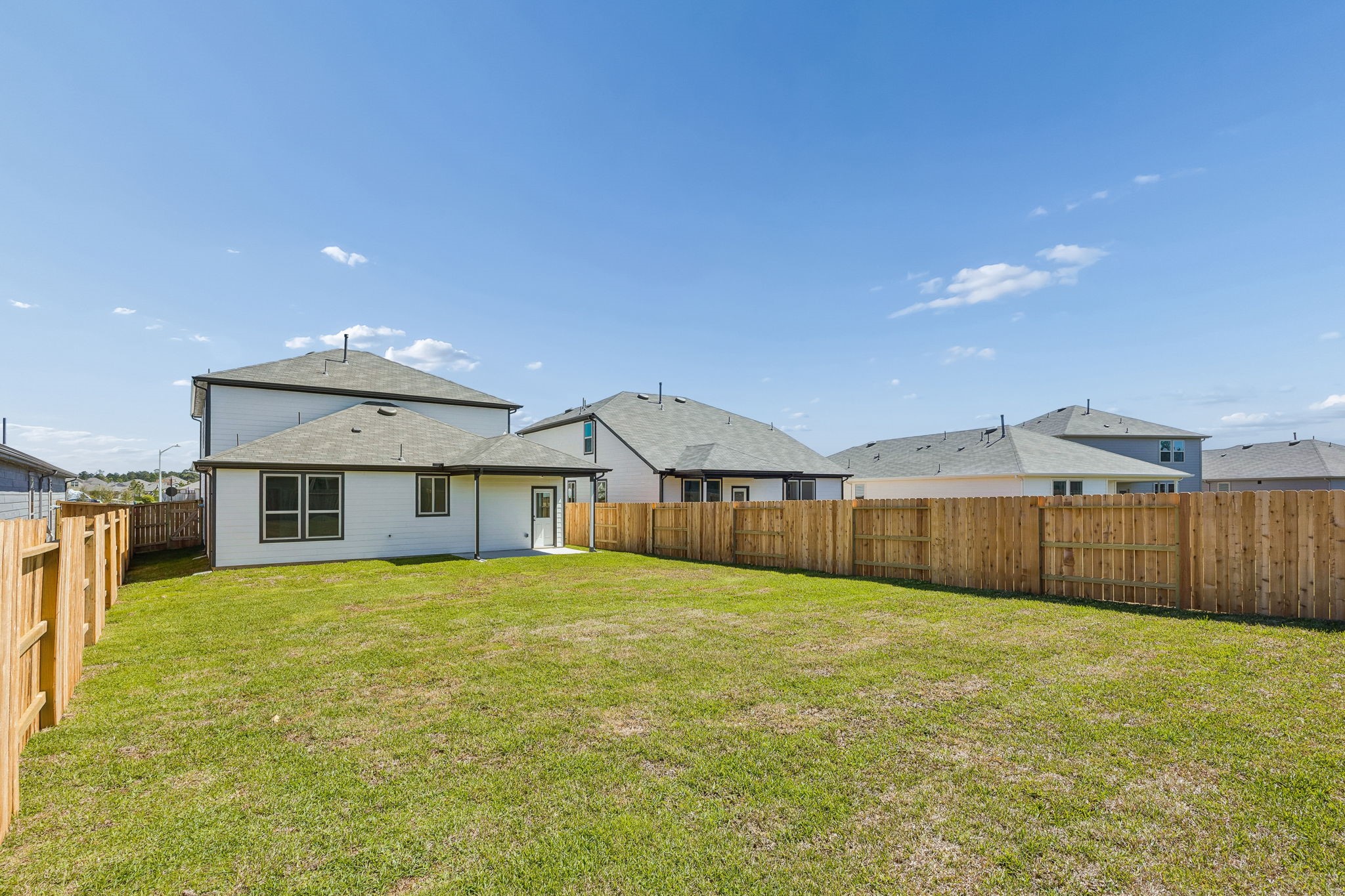 15015 Rustic Moon Road Conroe, TX 77302 - Photo 27 of 34 a view of a house with a yard and fence