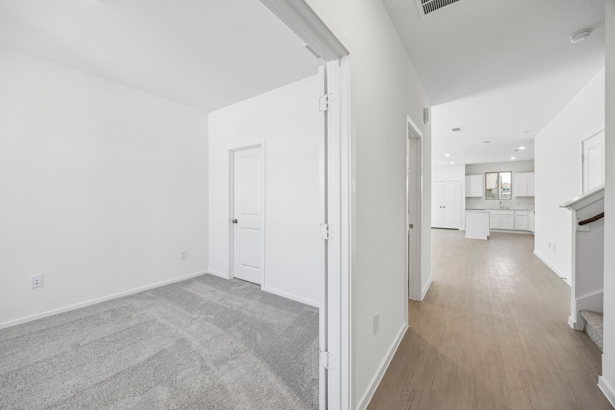 15015 Rustic Moon Road Conroe, TX 77302 - Photo 3 of 34 a view of a hallway with wooden floor kitchen and a sink