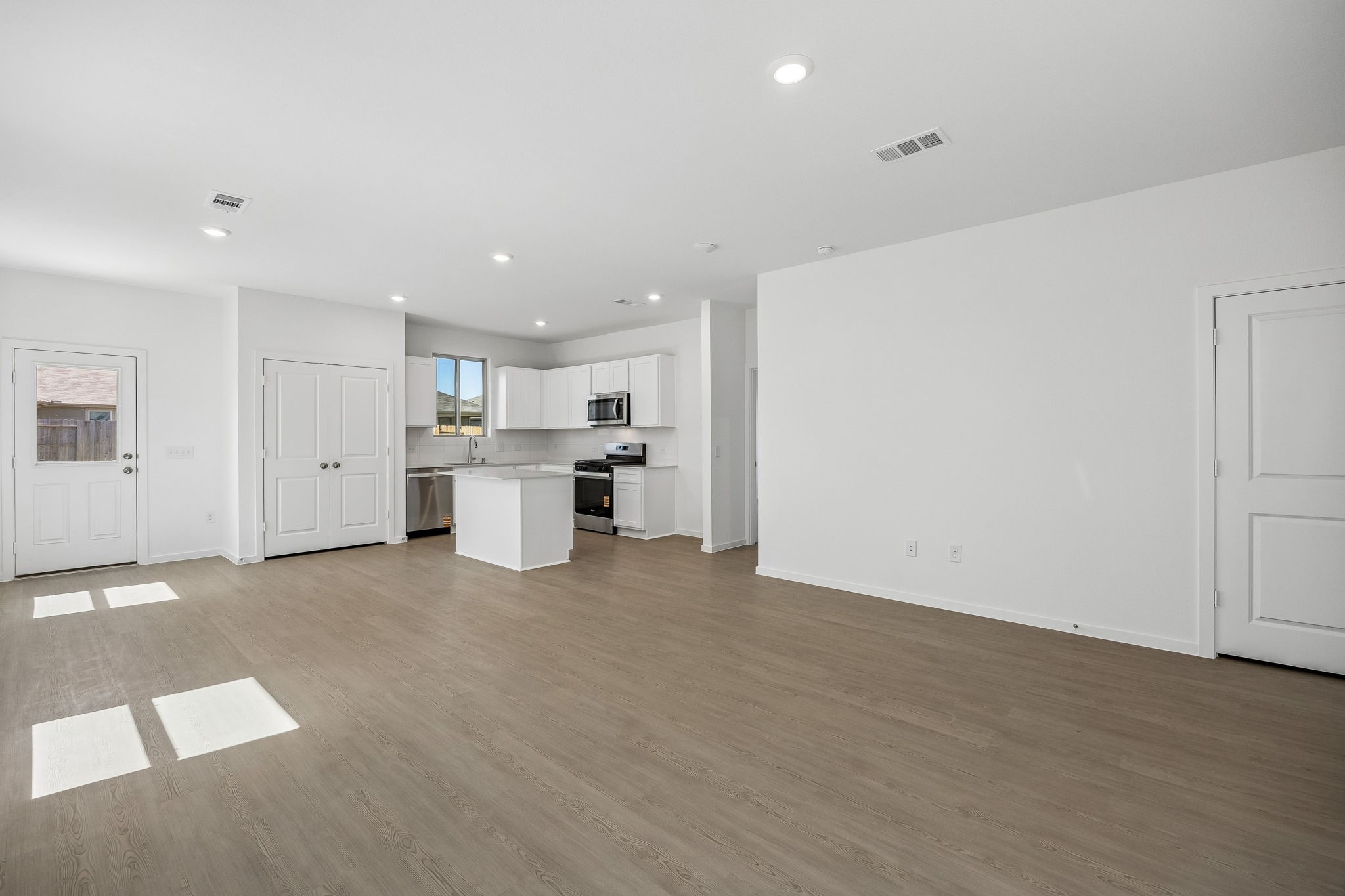 15015 Rustic Moon Road Conroe, TX 77302 - Photo 6 of 34 a view of a kitchen with refrigerator and white walls