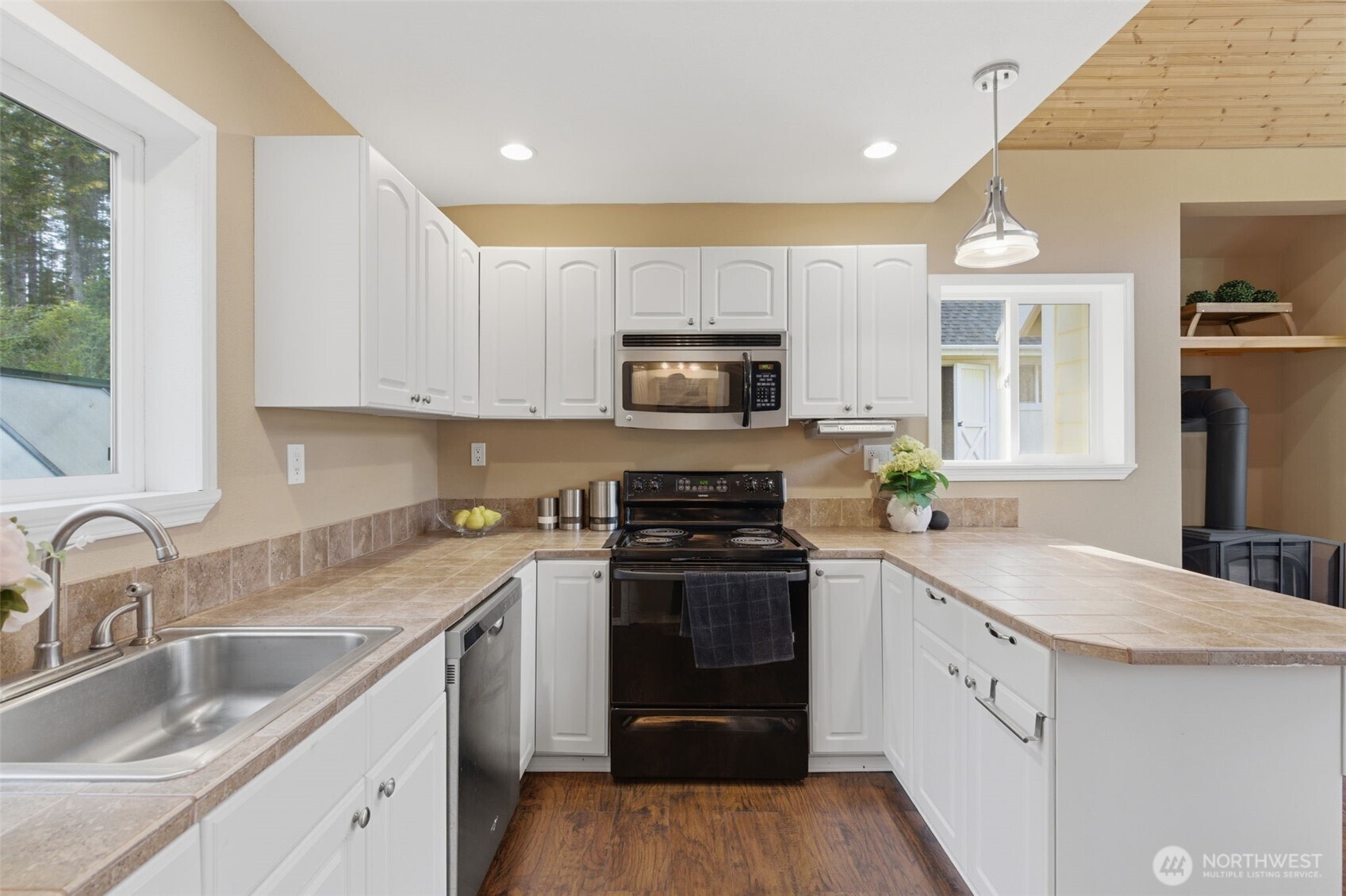 6971 Northeast Tahuya Blacksmith Road Belfair, WA 98528 - Photo 17 of 38 a kitchen with granite countertop a sink stainless steel appliances and cabinets