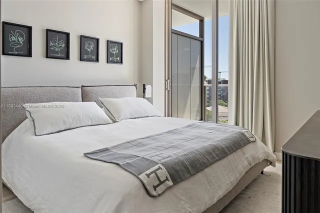 a bedroom with bed and window