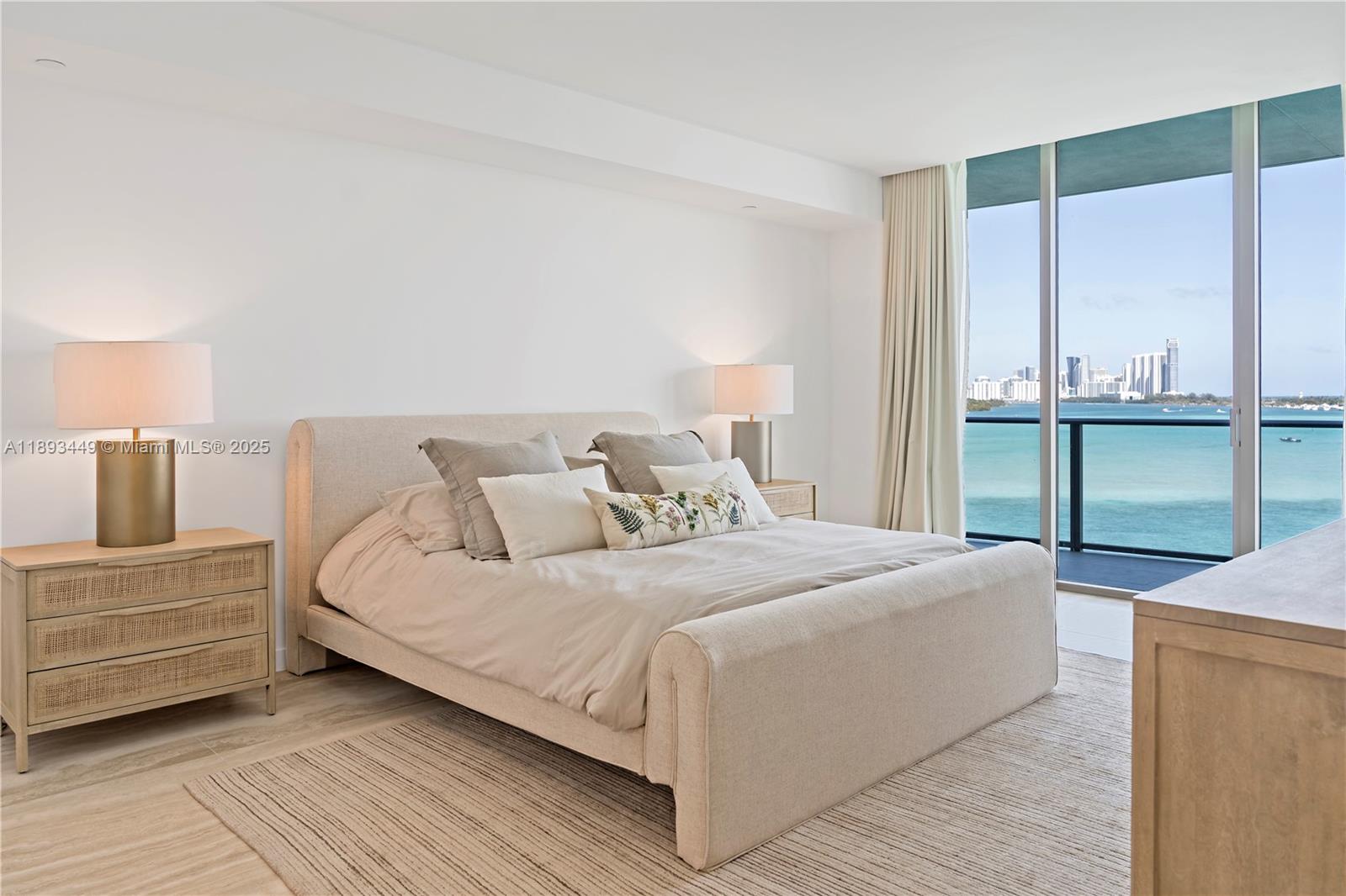 1135 103rd Street, Unit PH2 Bay Harbor Islands, FL 33154 - Photo 8 of 20 a bedroom with a bed and a table