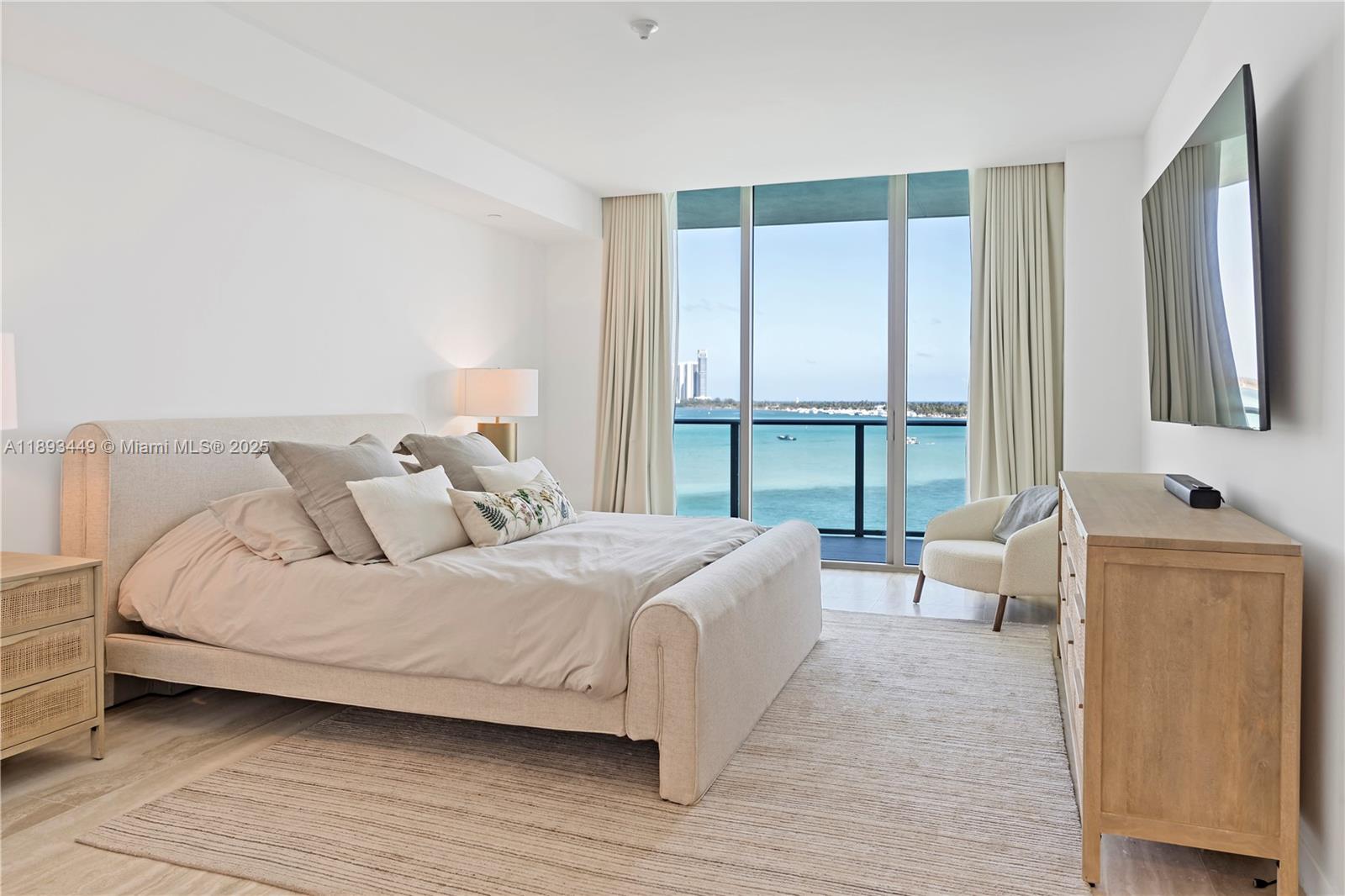 1135 103rd Street, Unit PH2 Bay Harbor Islands, FL 33154 - Photo 9 of 20 a bedroom with a bed and large window