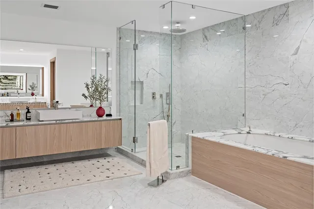 a bathroom with a tub sink and mirror