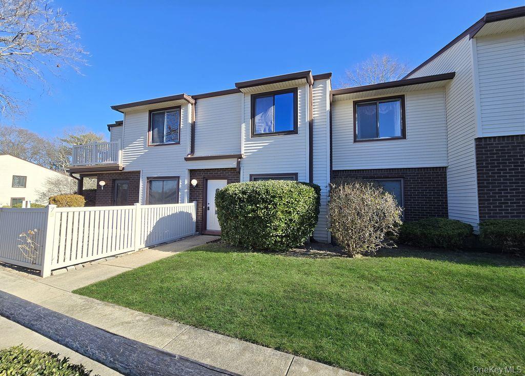 a view of a house with a yard and pathway