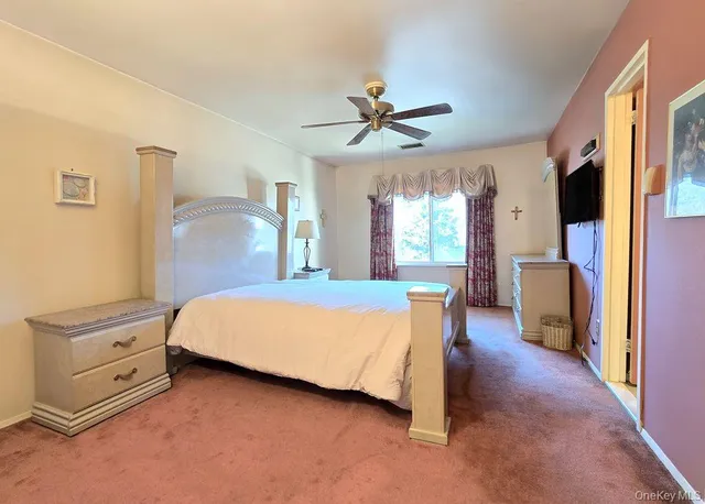 a bedroom with a bed dresser and a window