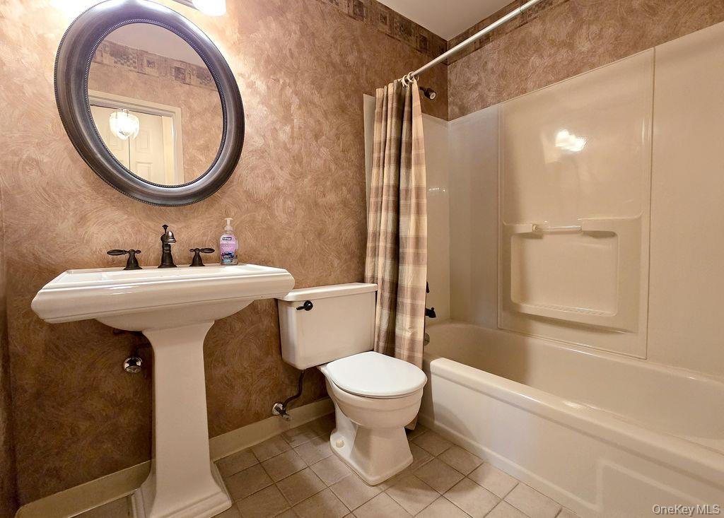 79 Birchwood Road Coram, NY 11727 - Photo 9 of 12 a bathroom with a sink toilet and shower