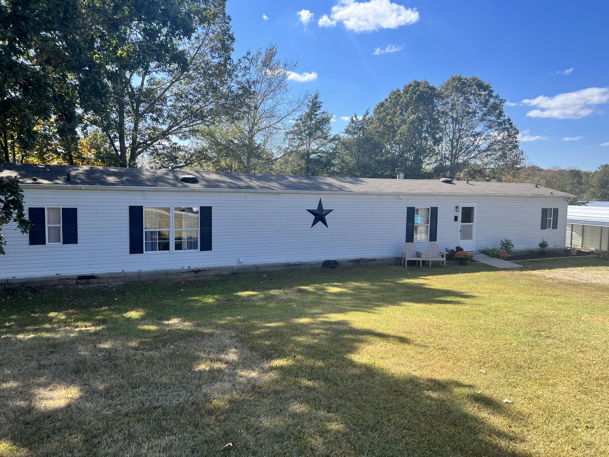 a view of a house with swimming pool next to a yard