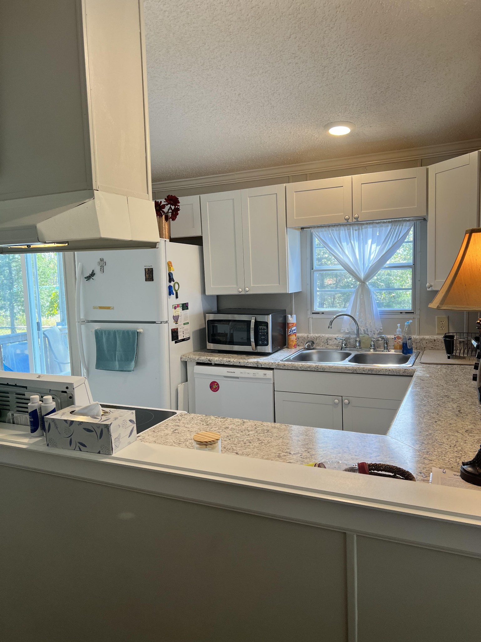 20002 Cessna Road Bon Aqua, TN 37025 - Photo 12 of 28 a kitchen with kitchen island a sink appliances cabinets and a counter top space