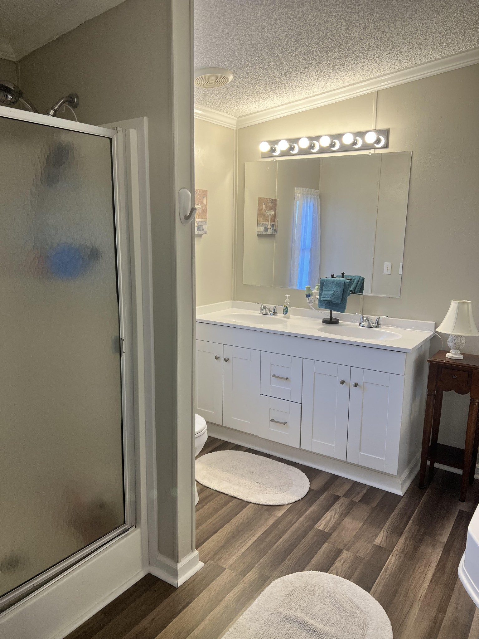 20002 Cessna Road Bon Aqua, TN 37025 - Photo 20 of 28 a bathroom with a toilet a sink a mirror and a shower