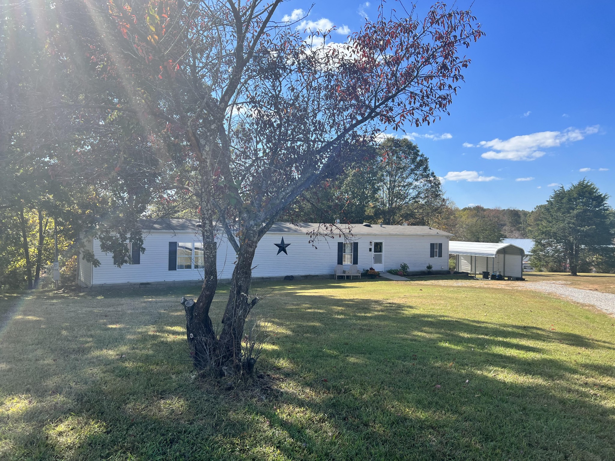 20002 Cessna Road Bon Aqua, TN 37025 - Photo 2 of 28 a front view of a house with a yard and garage