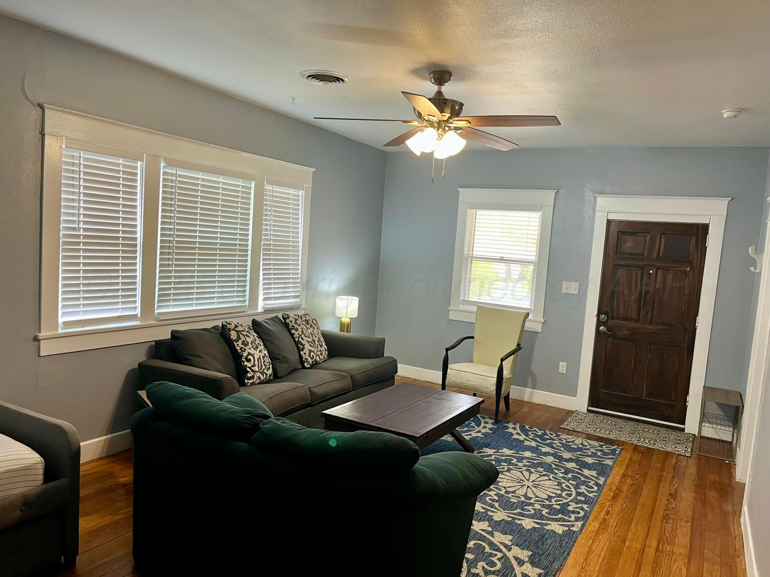 2011 5th Avenue Canyon, TX 79015 - Photo 3 of 12 a living room with furniture and a wooden floor