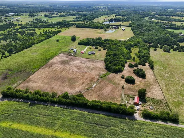 an aerial view of residential houses with outdoor space and river