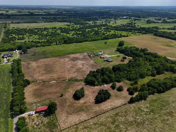 an aerial view of a house with a yard
