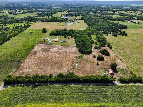 an aerial view of residential houses with outdoor space and lake view