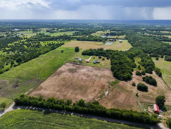 an aerial view of a houses with outdoor space and river