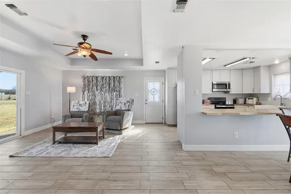 a view of living room kitchen with furniture and wooden floor