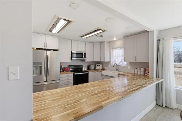 a kitchen with stainless steel appliances granite countertop a refrigerator sink and microwave