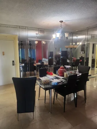 a kitchen with a dining table chairs and a chandelier