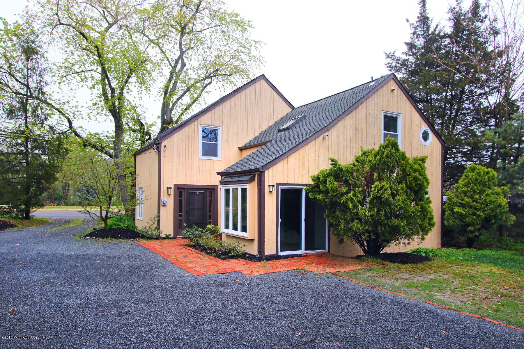 186 Pinebrook Road Tinton Falls, NJ 07724 - Photo 12 of 41 a front view of house with small garden and tree