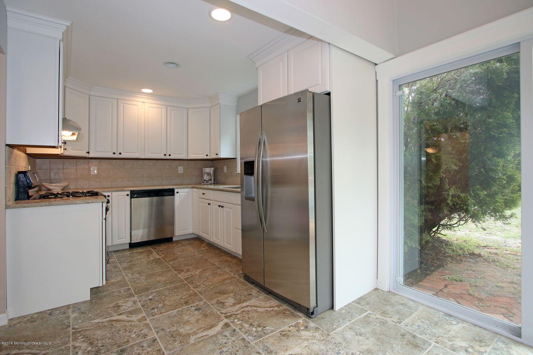 186 Pinebrook Road Tinton Falls, NJ 07724 - Photo 13 of 41 a kitchen with a stove a refrigerator and a sink