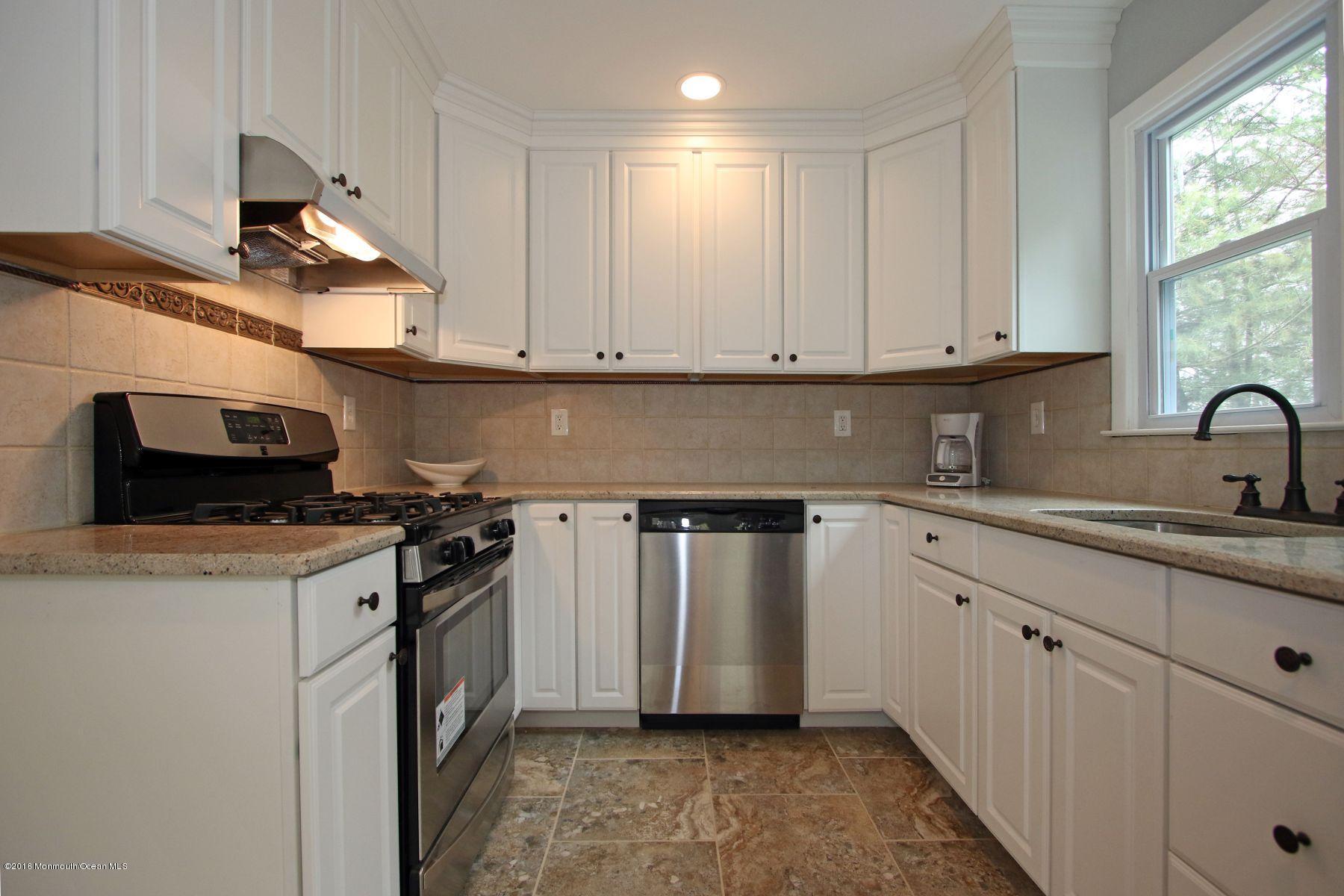 186 Pinebrook Road Tinton Falls, NJ 07724 - Photo 14 of 41 a kitchen with stainless steel appliances granite countertop a sink stove and cabinets