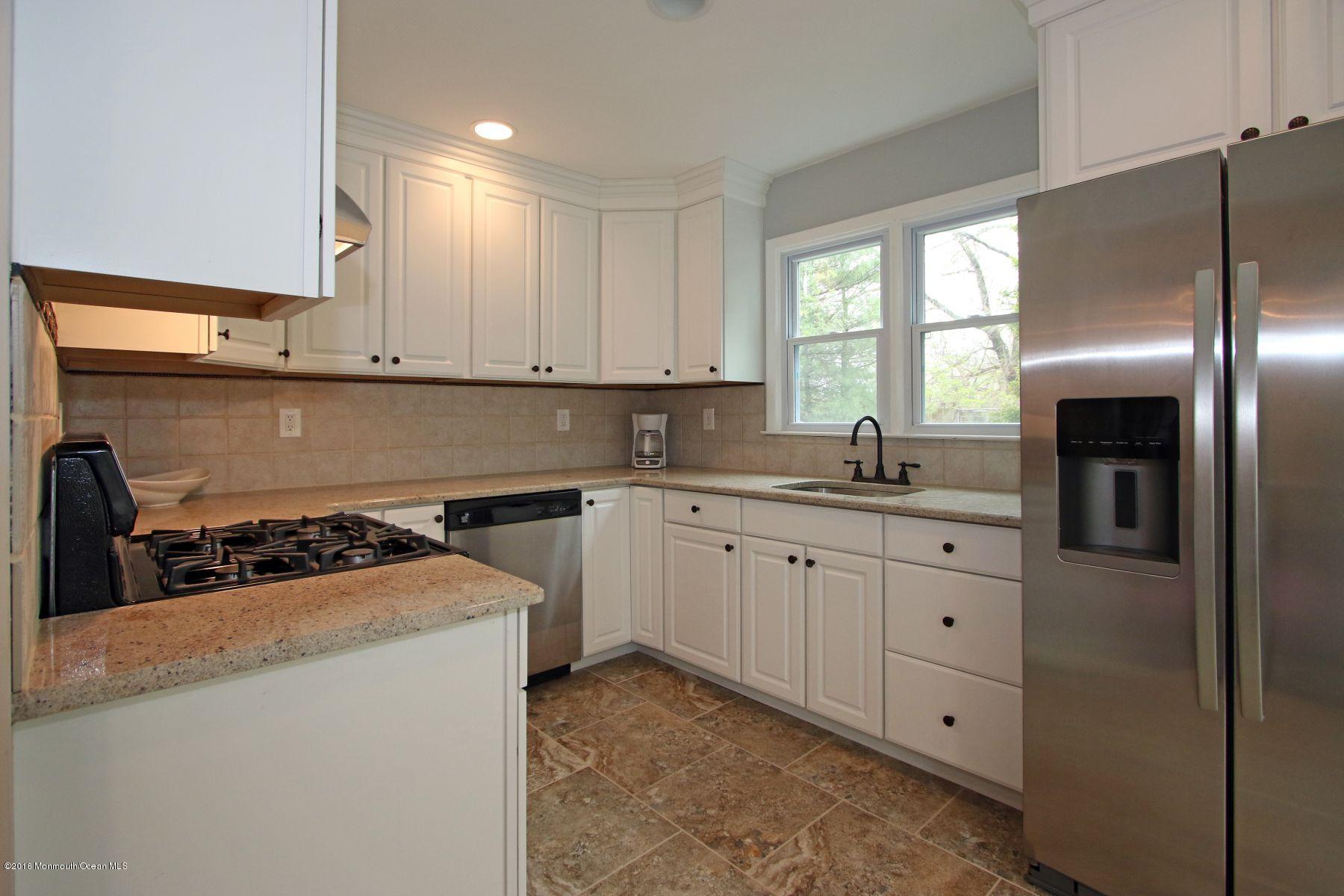 186 Pinebrook Road Tinton Falls, NJ 07724 - Photo 15 of 41 a kitchen with cabinets appliances a sink and a window