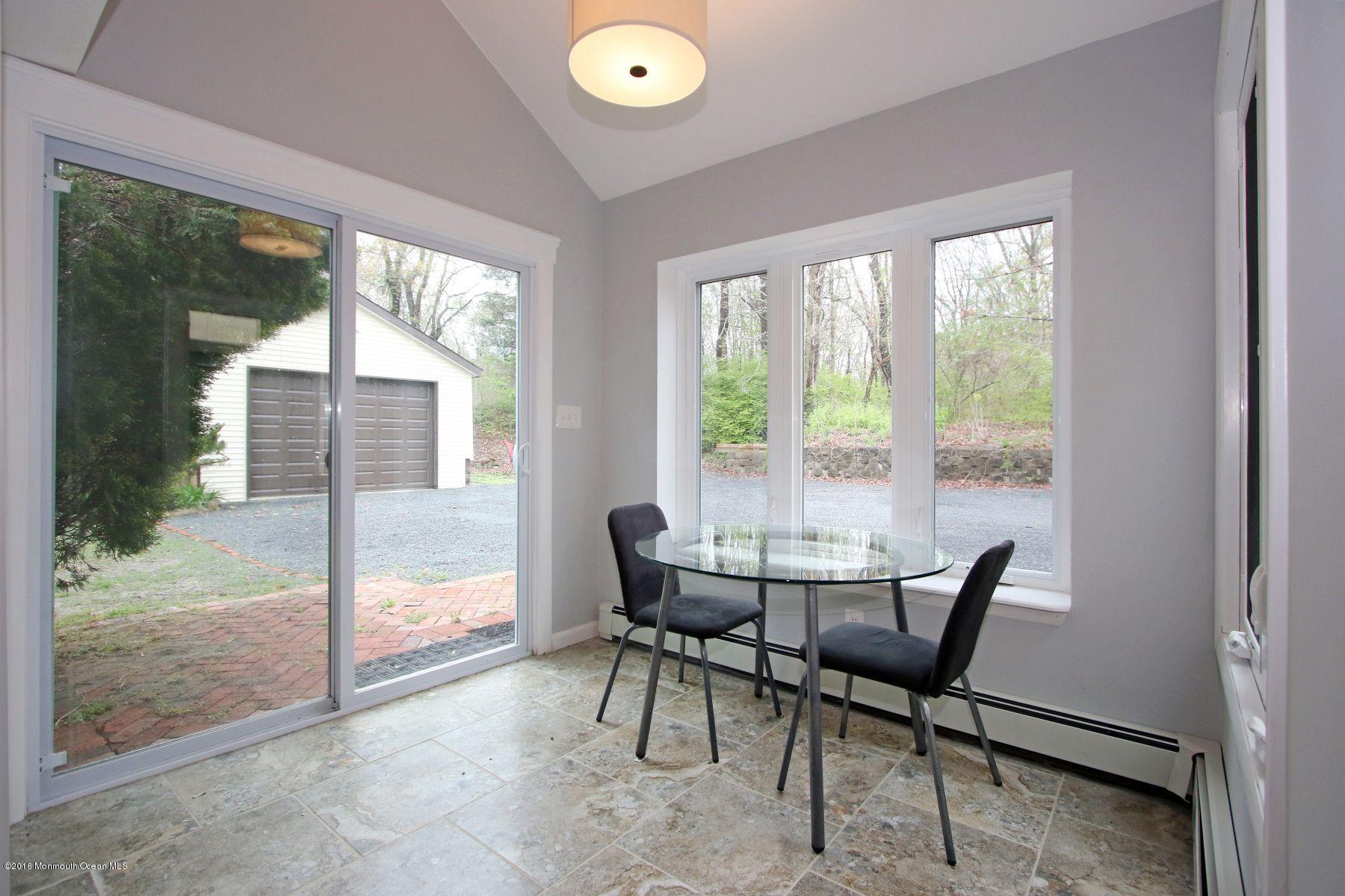186 Pinebrook Road Tinton Falls, NJ 07724 - Photo 16 of 41 a dining room with furniture and a floor to ceiling window