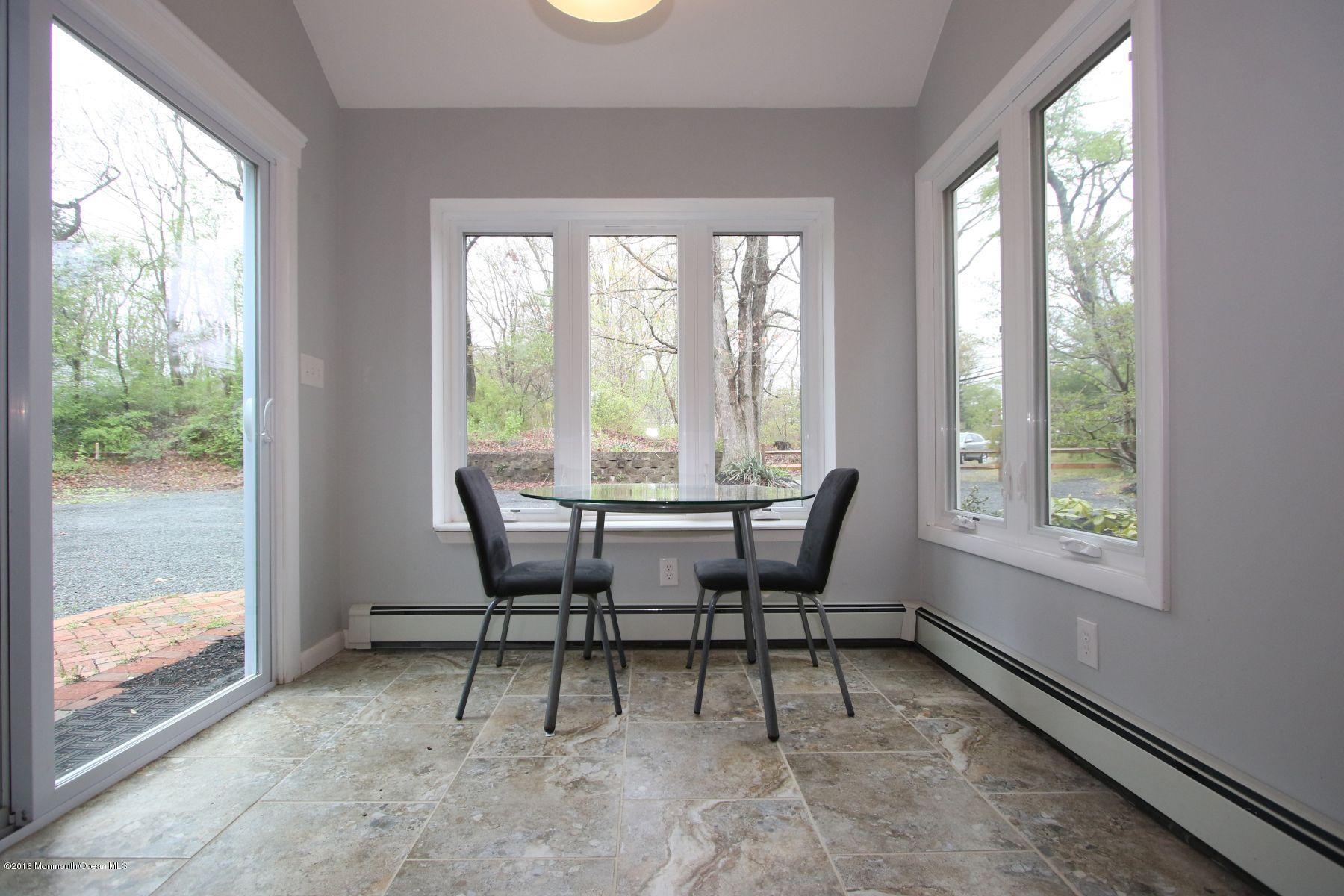 186 Pinebrook Road Tinton Falls, NJ 07724 - Photo 17 of 41 a dining room with furniture and a floor to ceiling window