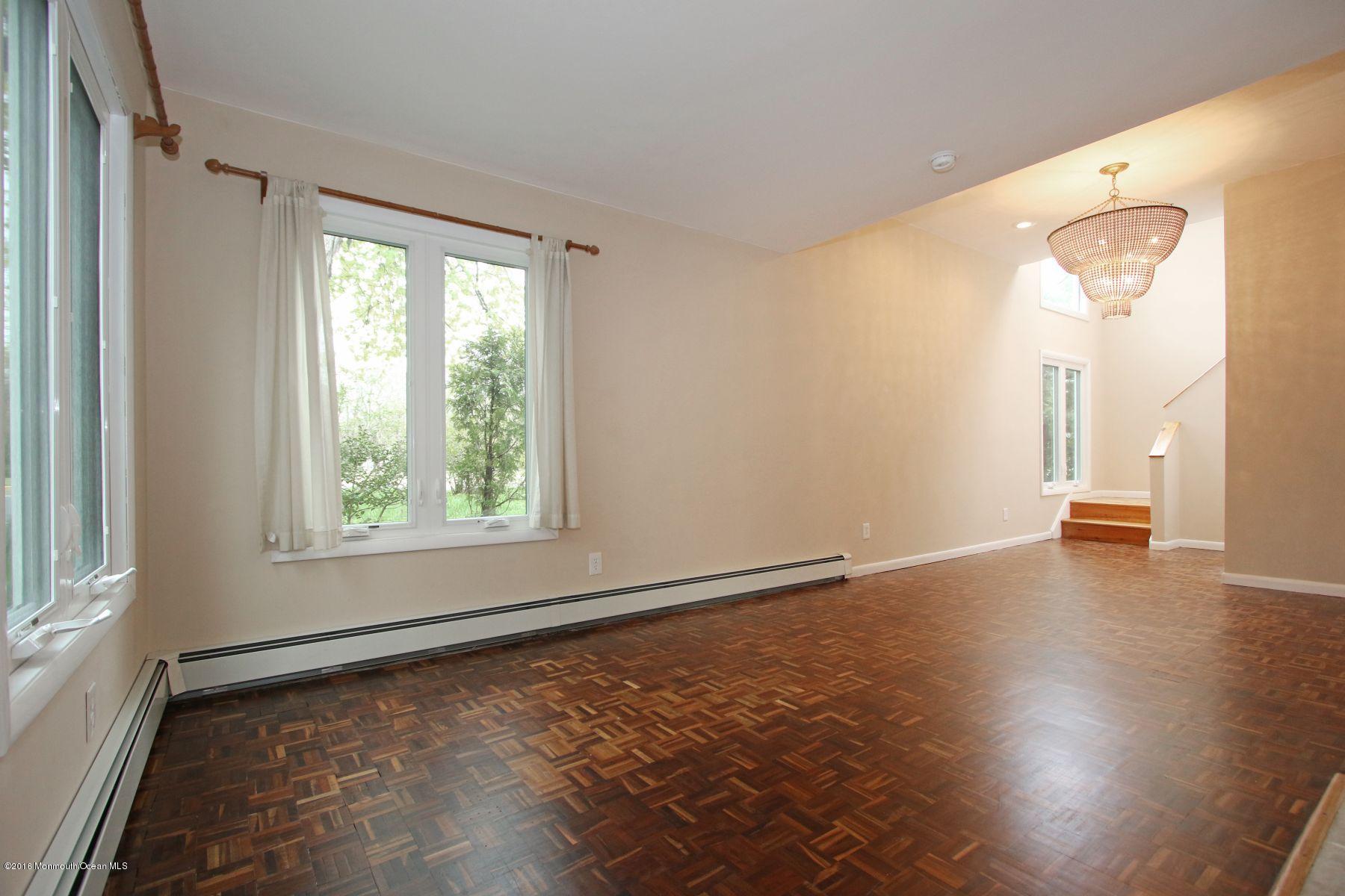 186 Pinebrook Road Tinton Falls, NJ 07724 - Photo 20 of 41 an empty room with wooden floor and windows