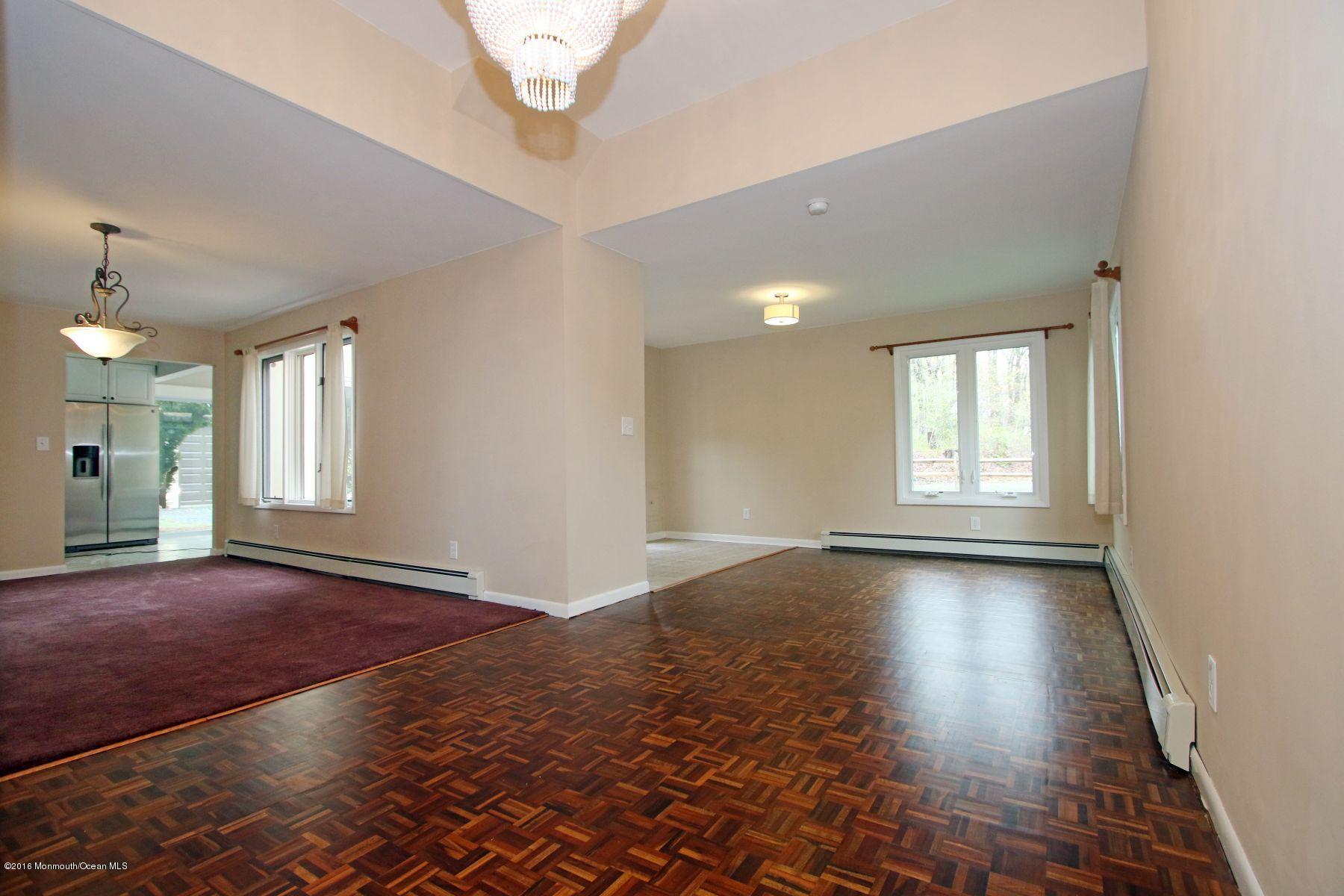 186 Pinebrook Road Tinton Falls, NJ 07724 - Photo 22 of 41 an empty room with wooden floor and windows