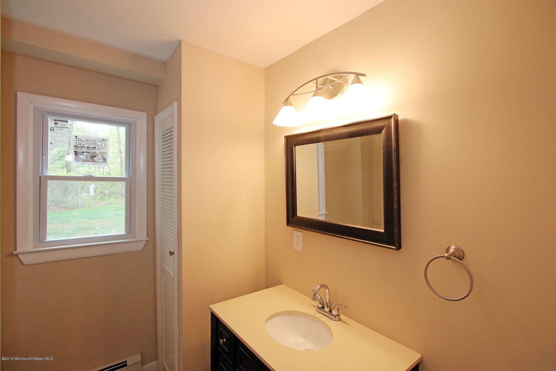 186 Pinebrook Road Tinton Falls, NJ 07724 - Photo 26 of 41 a bathroom with a sink mirror and vanity