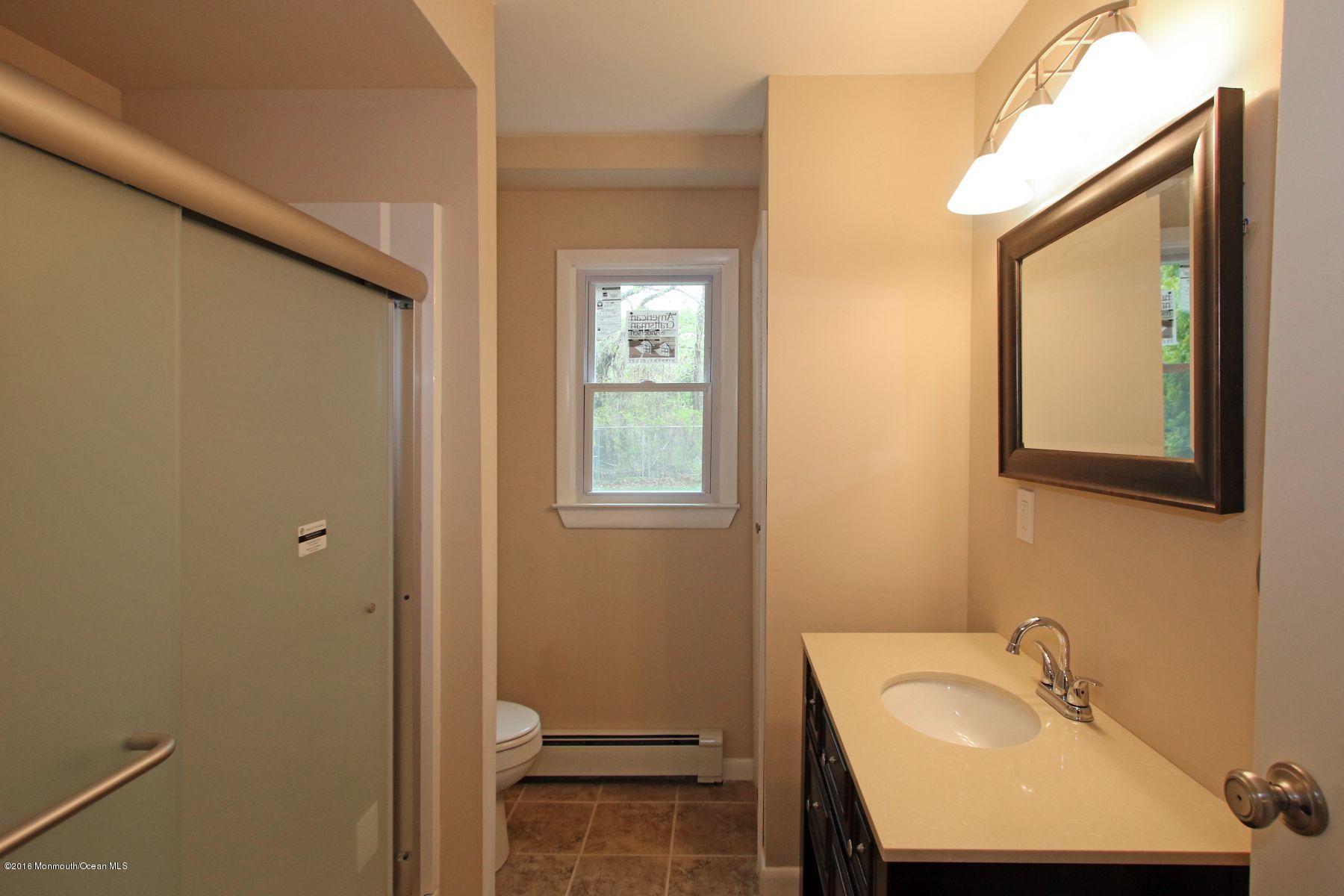 186 Pinebrook Road Tinton Falls, NJ 07724 - Photo 27 of 41 a bathroom with a sink a toilet and mirror