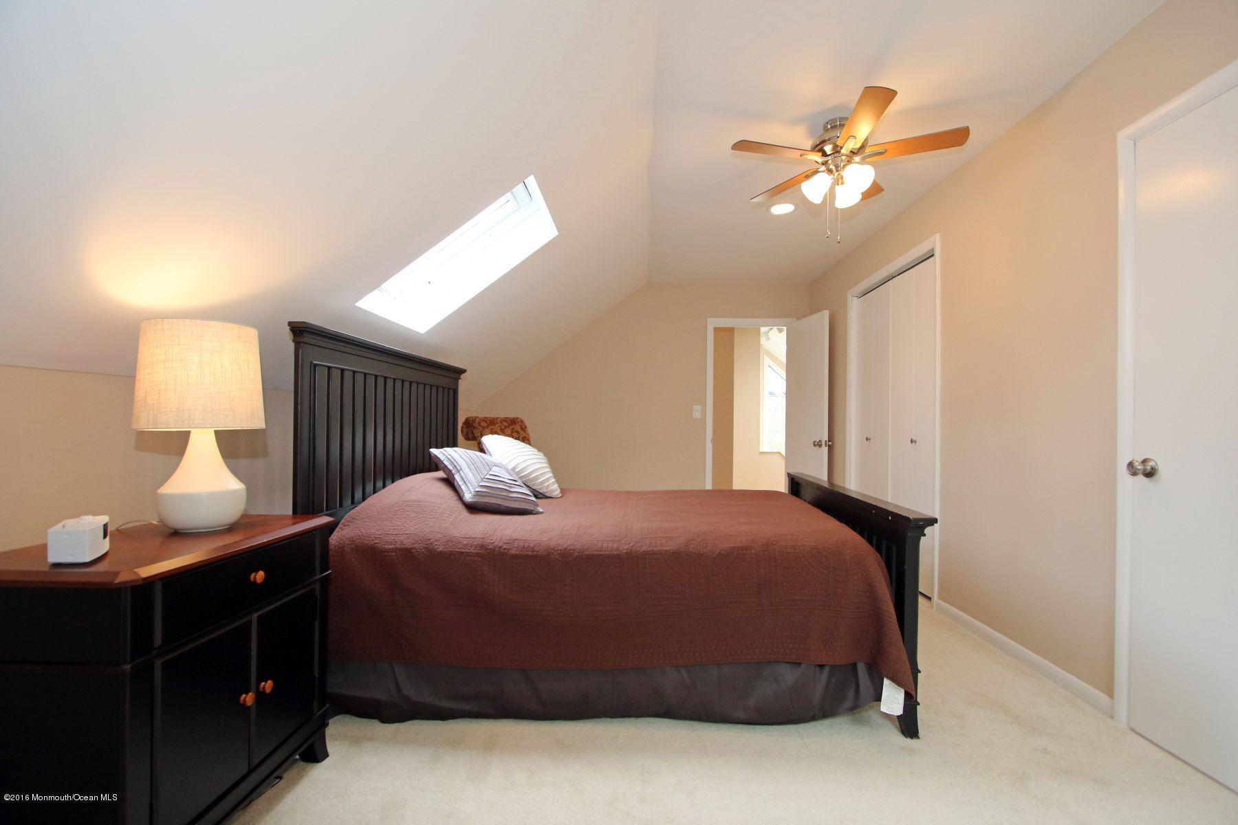 186 Pinebrook Road Tinton Falls, NJ 07724 - Photo 31 of 41 a bedroom with a bed and a lamp